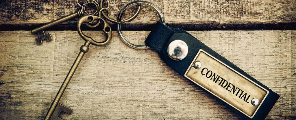 Keys with a keychain with the words confidential on it